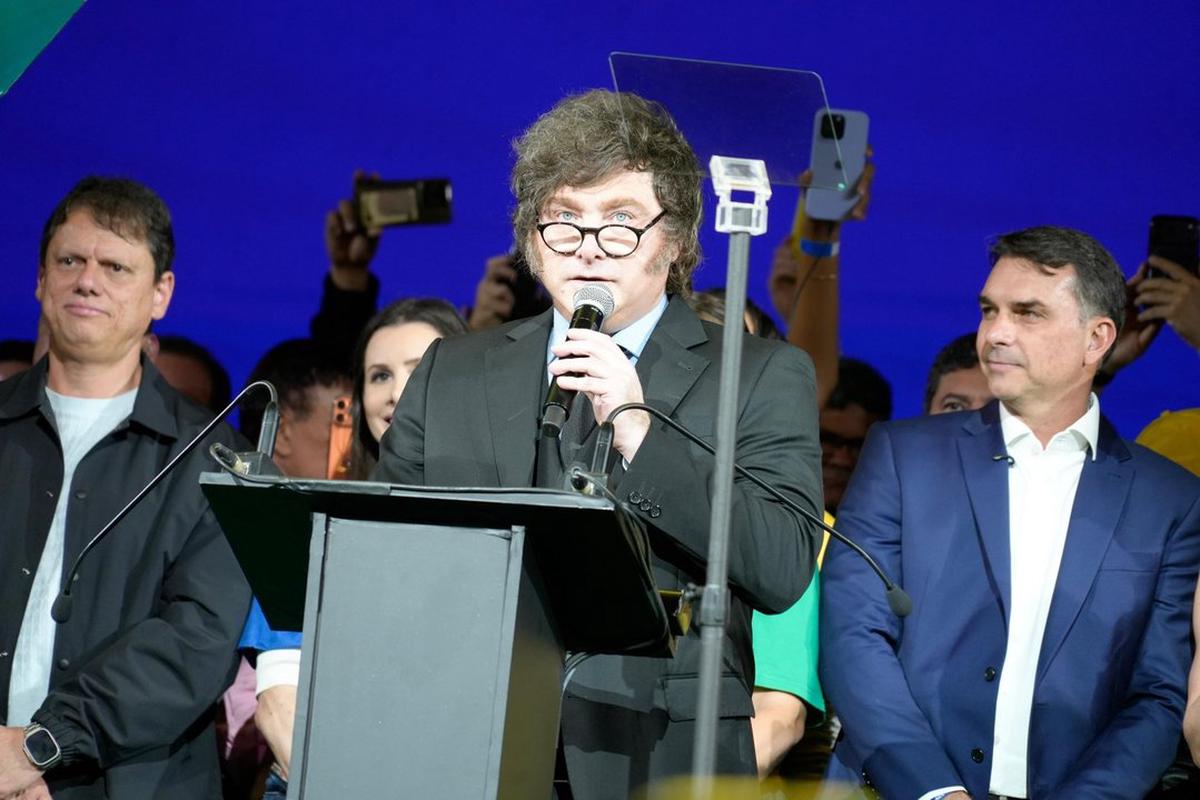 El presidente Javier Milei habla en la convención del Partido Liberal en San Pablo. A su lado el candidato presidencial Flávio Bolsonaro