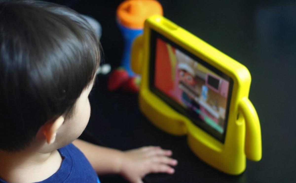 Niños usando pantallas.